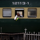 A train passenger wets his face to cool off.
